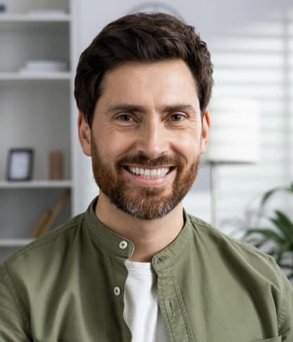Smiling man relieved after emergency dental care